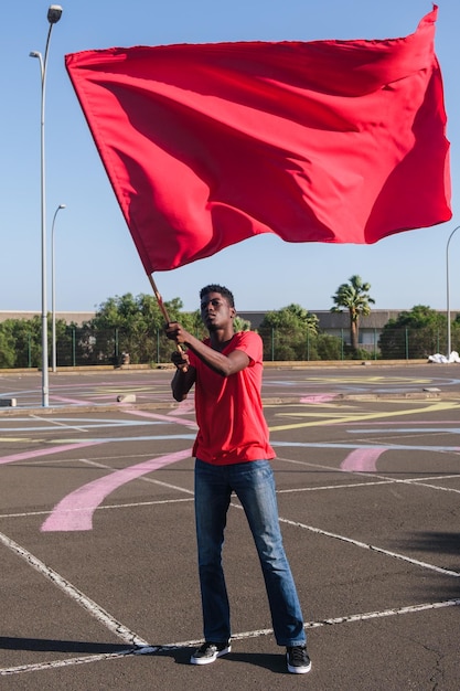 Young man waving his team39s flag outdoors just before the big game