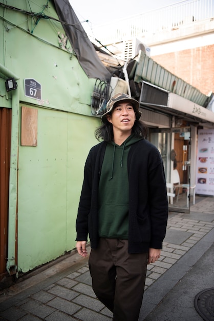 Young man wearing a bucket hat in the city