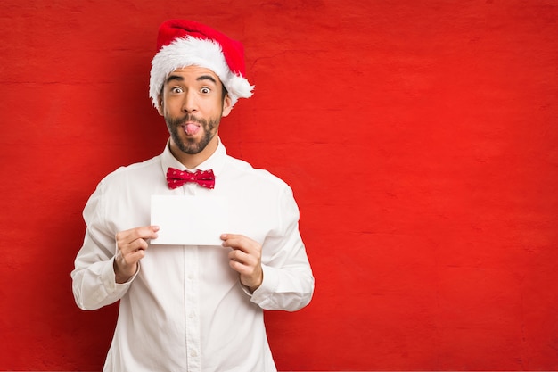 Young man wearing a santa claus hat on Christmas day