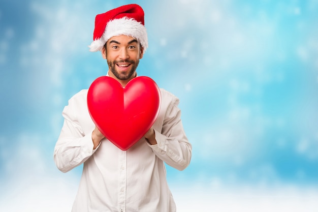 Young man wearing a santa claus hat on Christmas day