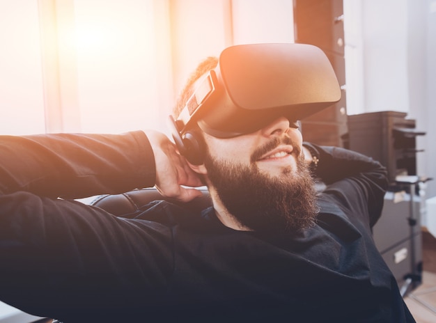 The young man wearing virtual reality goggles