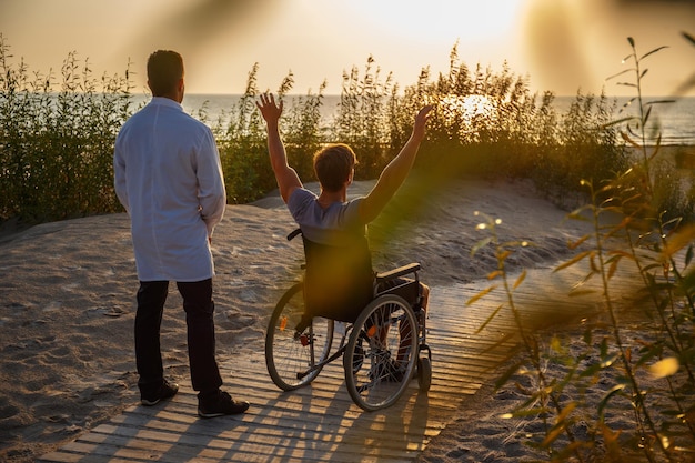 Young man in wheelchair and his doctor.