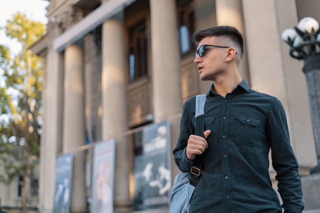 Young man with backpack exploring old city