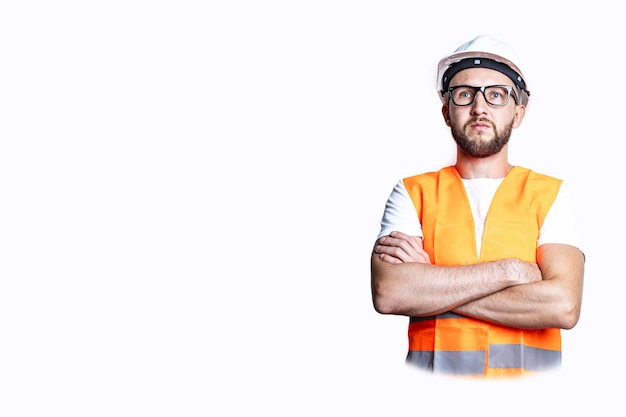 Young man with a beard in casual clothes crossing his arms on a light background