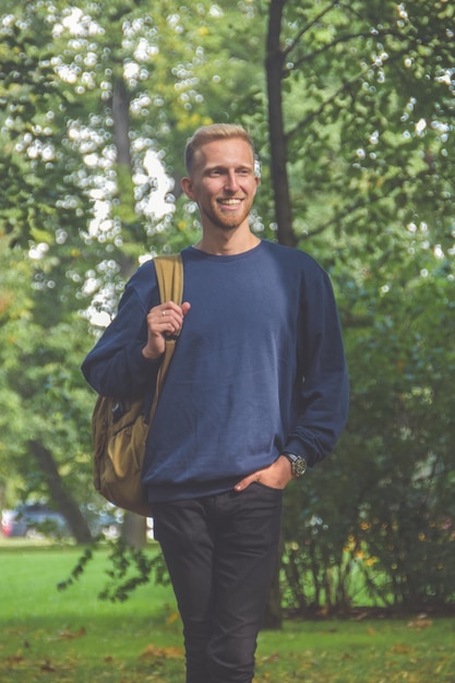 The young man with a beard in a Park among the trees