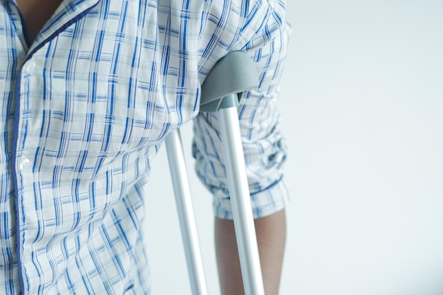 Young man with broken leg on crutches