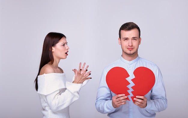 young man with a broken red heart.