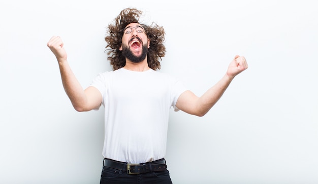 Young man with crazy hair in motion celebrating success