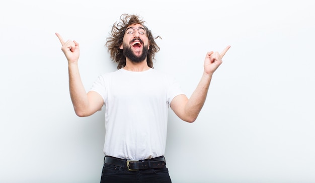 Young man with crazy hair in motion celebrating success