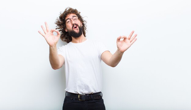 Young man with crazy hair in motion celebrating success