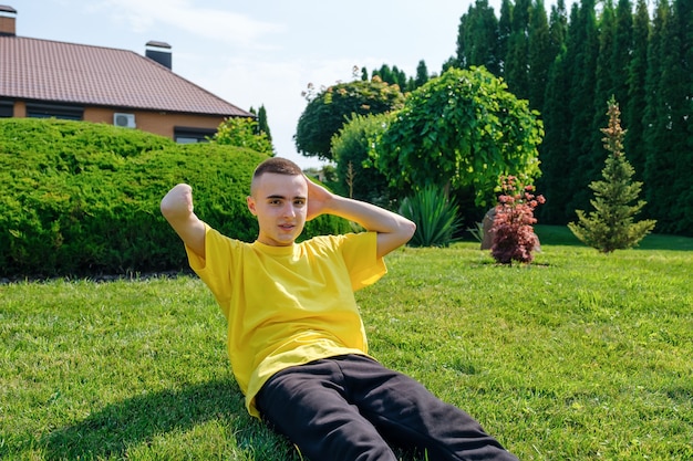 Young man with disability exercising in yard