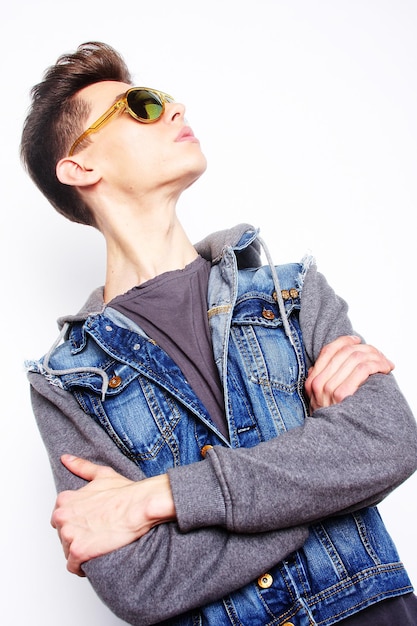 Young man with fashionable sunglasses on white background