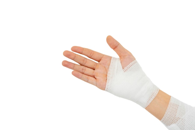 Photo young man with gauze bandage wrapped around injury hand on white background