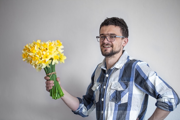 young man with glasses and a bouquet of flowers.