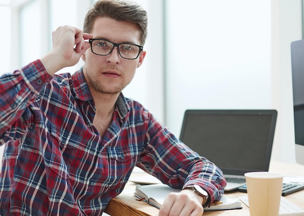 Young man with glasses working on his notebook getting the business out of the way