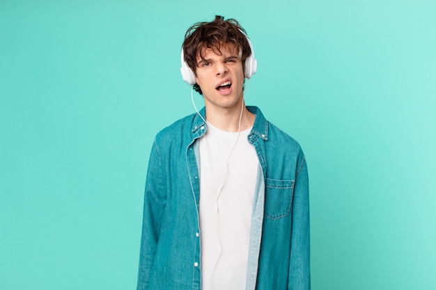 Young man with headphones feeling puzzled and confused