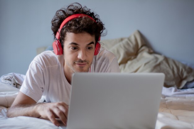 Young man with headphones and using laptop