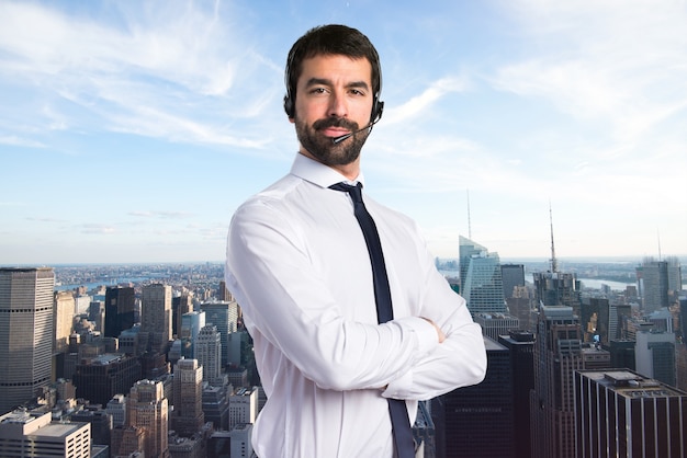 Young man with a headset on unfocused background