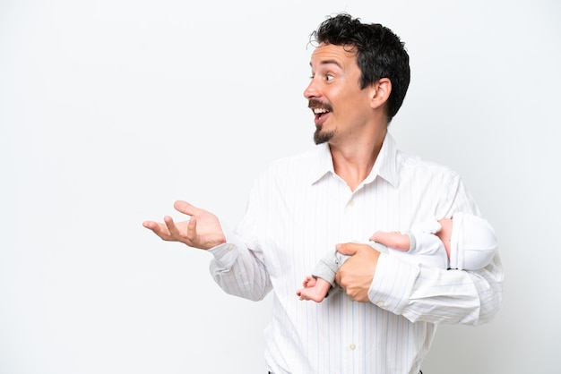 Young man with his newborn baby with surprise facial expression