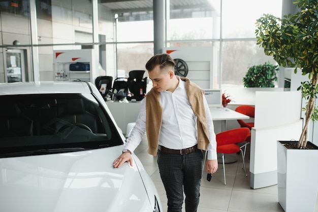 Young man with the keys at the car