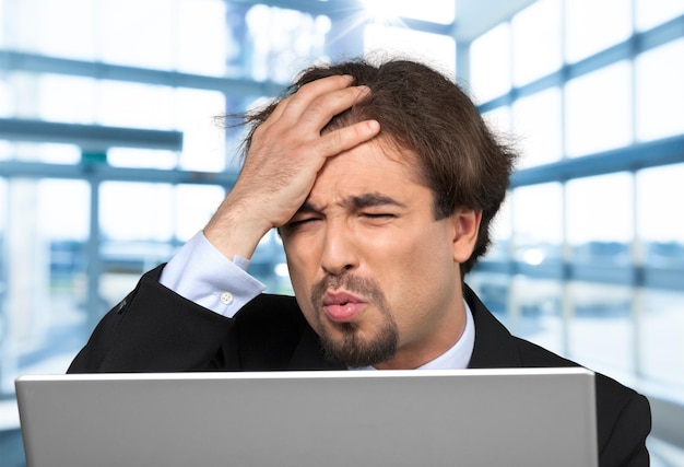 Young man with laptop at data centre