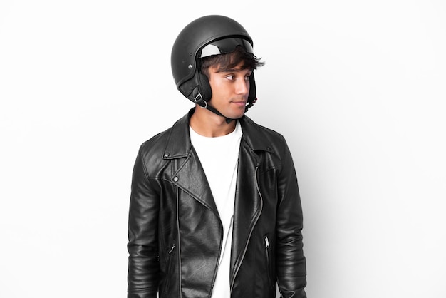 Young man with a motorcycle helmet isolated on white background looking to the side