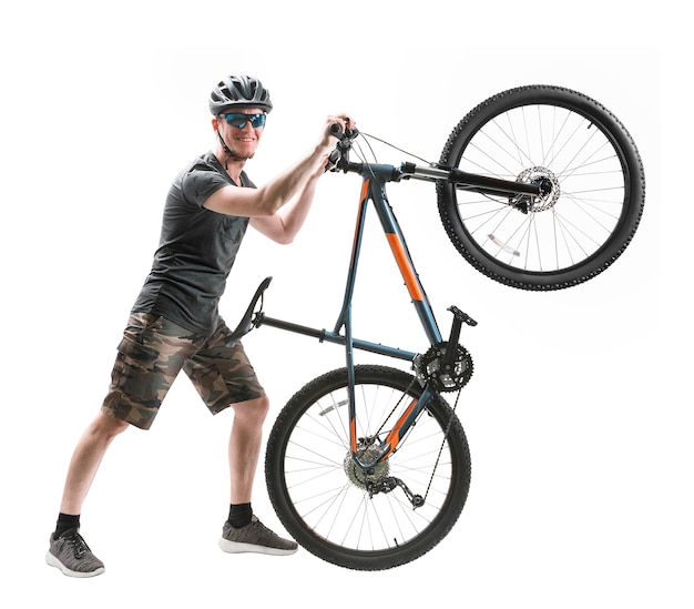 Young man with mountain bike isolated on white