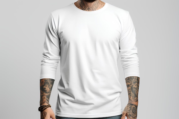 Young man with tattoos wearing a white long sleeve tee