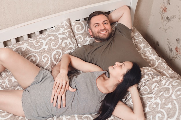 Young man and woman on bed