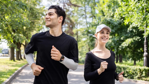 Young man and woman happy friends people doing fitness runners together in running clothes