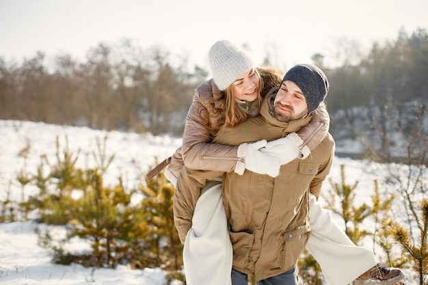 Young man and woman spending time together at winter day