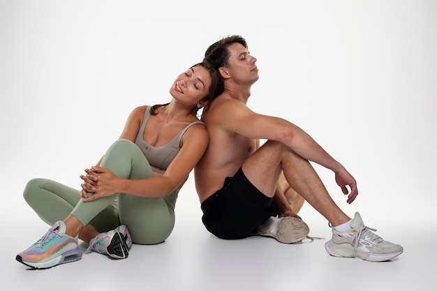 Young man and woman training together for bodybuilding