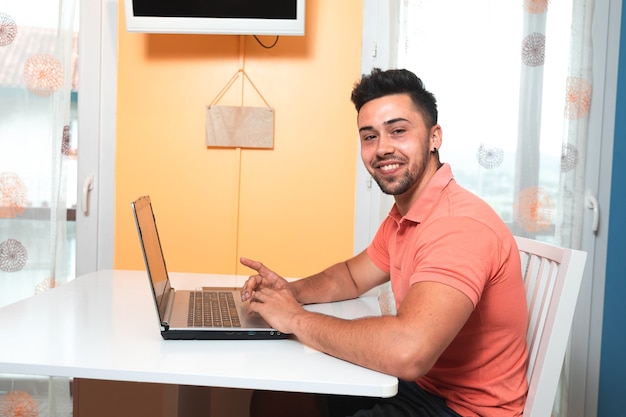 Young man working at home with a laptop