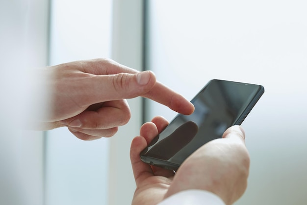 Young man writes an SMS to your mobile phone