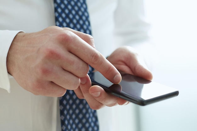 Young man writes an SMS to your mobile phone