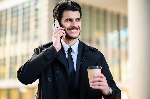 Young manager on the phone outdoor in an urban setting