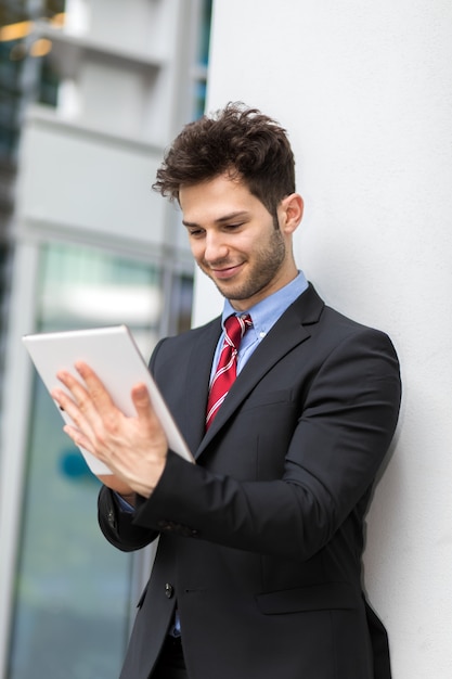 Young manager using a digital tablet outdoor