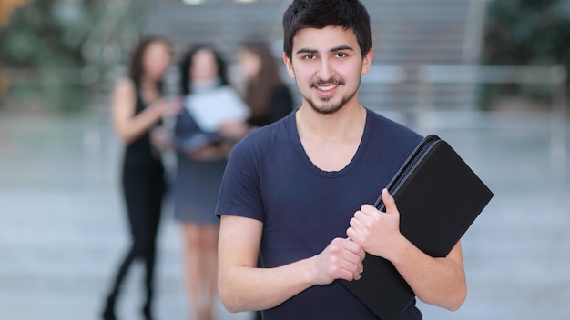 Young manager with documents on the background of the office