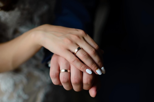 Young married couple holding hands ceremony wedding day