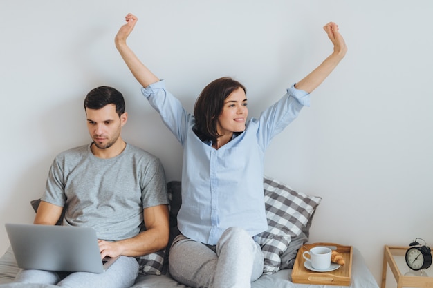 Young married couple spend morning in bed.