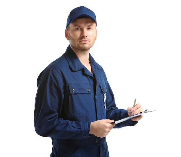 Young mechanic in uniform with a clipboard and pen isolated on white