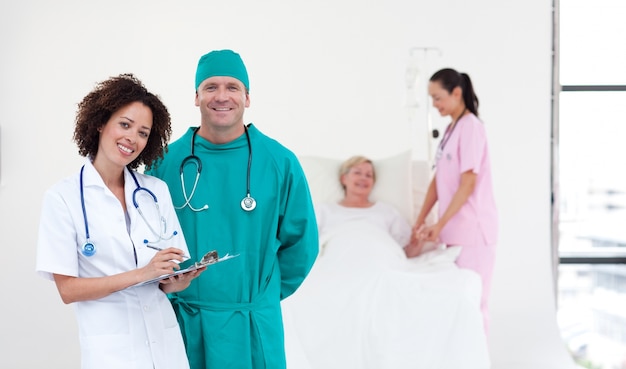 Young medical team standing near  a patient