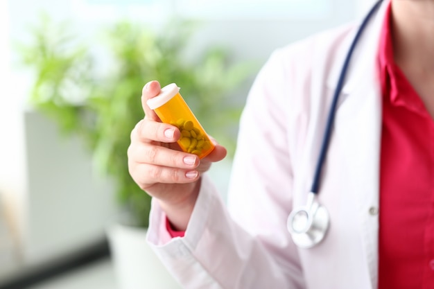 Young medical worker giving recommendations of vitamins