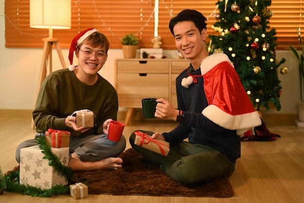 Young men celebrating Christmas or New Year together at cozy home Holidays and celebration concept