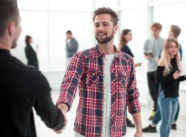 Young men greeting each other in the creative office