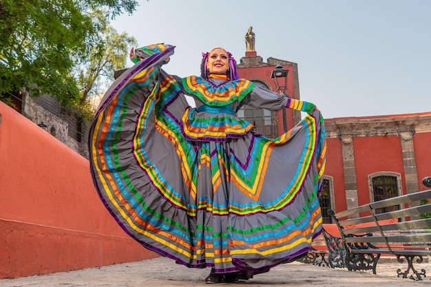 Young mexican woman in a traditional folklore dress of many colors traditional dancer