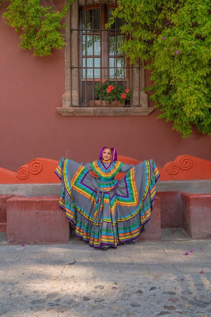 Young mexican woman in a traditional folklore dress of many colors traditional dancer