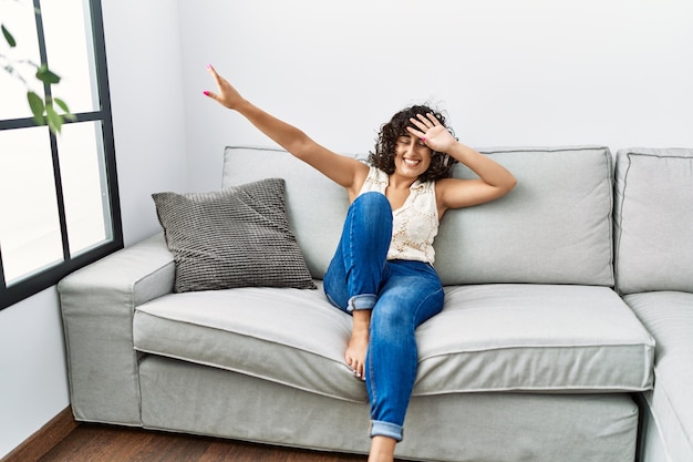 Young middle east woman smiling confident listening to music at home