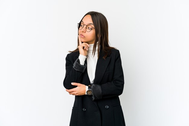 Young mixed race business woman isolated on white background contemplating, planning a strategy, thinking about the way of a business.