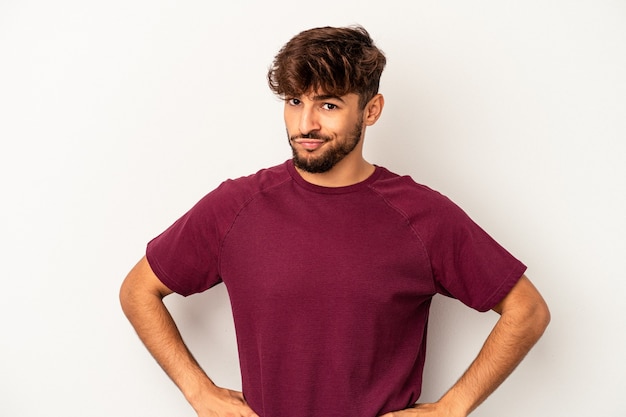 Young mixed race man isolated on grey background confused, feels doubtful and unsure.